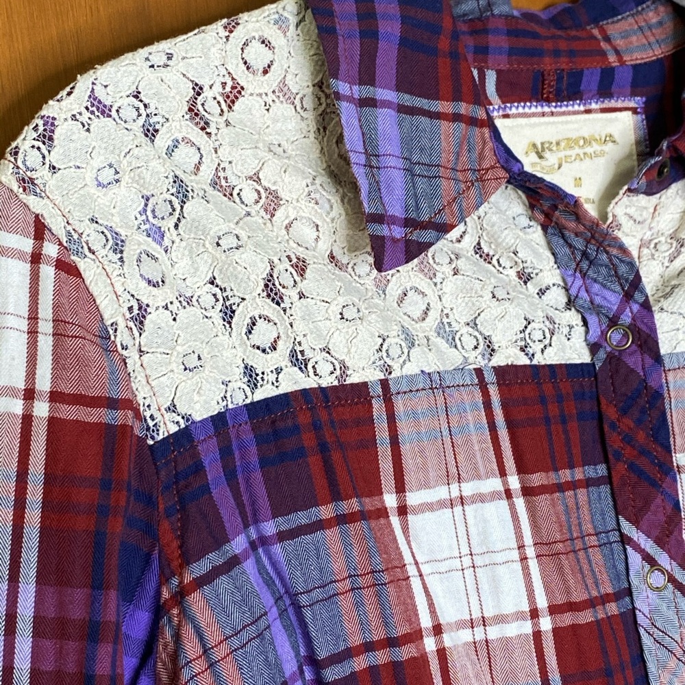 Fun plaid button shirt with floral lace detail.